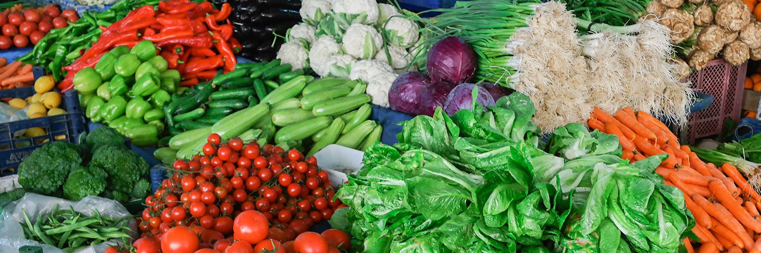 Fresh vegetables and fruits on a market stall.