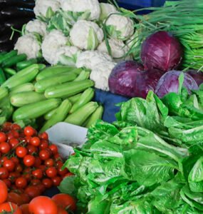 Fresh vegetables and fruits on a market stall.