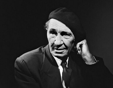 Black and white portrait of Cevat Sakir Kabaagacli, the Fisherman of Halicarnassus, wearing a beret and suit, symbolizing his intellectual legacy in Bodrum.