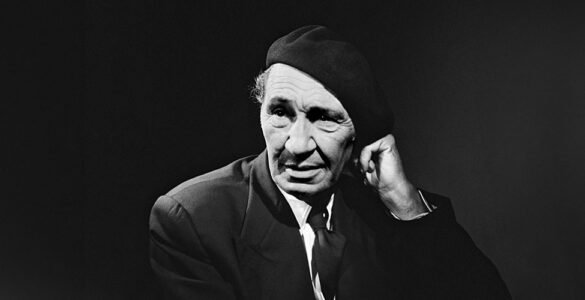 Black and white portrait of Cevat Sakir Kabaagacli, the Fisherman of Halicarnassus, wearing a beret and suit, symbolizing his intellectual legacy in Bodrum.