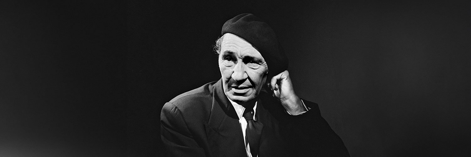 Black and white portrait of Cevat Sakir Kabaagacli, the Fisherman of Halicarnassus, wearing a beret and suit, symbolizing his intellectual legacy in Bodrum.