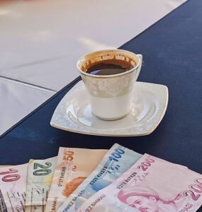 6 different banknotes of Turkish Lira and a Turkish café.