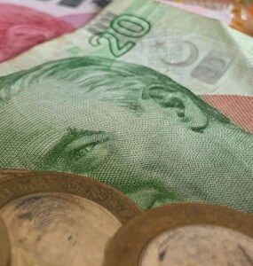Turkish lira banknotes and coins left as a tip on a table.