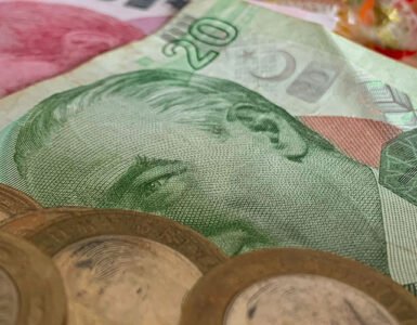 Turkish lira banknotes and coins left as a tip on a table.