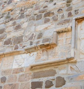 Several coat of arms of the Knights Hospitaller displayed on stone walls at Bodrum Castle, representing the history of Bodrum Castle.