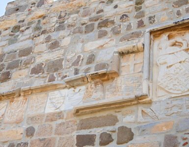 Several coat of arms of the Knights Hospitaller displayed on stone walls at Bodrum Castle, representing the history of Bodrum Castle.