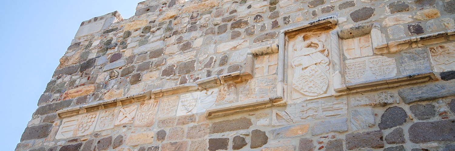 Several coat of arms of the Knights Hospitaller displayed on stone walls at Bodrum Castle, representing the history of Bodrum Castle.