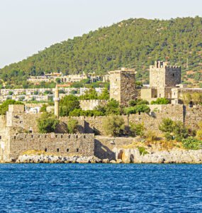 Bodrum Castle, sea front view, with Aegean Sea and sailing yachts in the foreground.