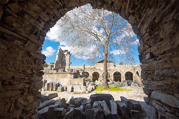 Ancient ruins in Iasos with stone arches.