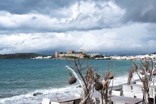 Stormy weather in Bodrum with dark clouds over the rough sea.