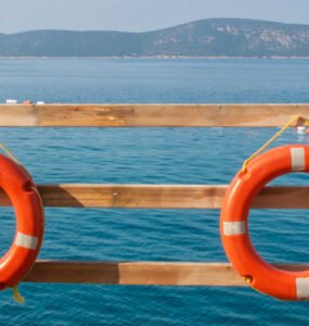 Featured photo of Yelken Beach with umbrellas and shoreline, representing beaches in Bodrum.