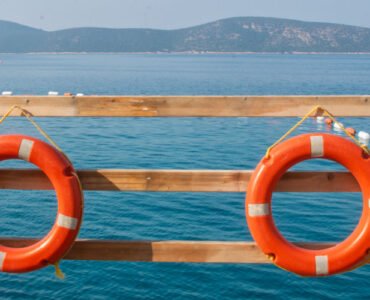 Featured photo of Yelken Beach with umbrellas and shoreline, representing beaches in Bodrum.