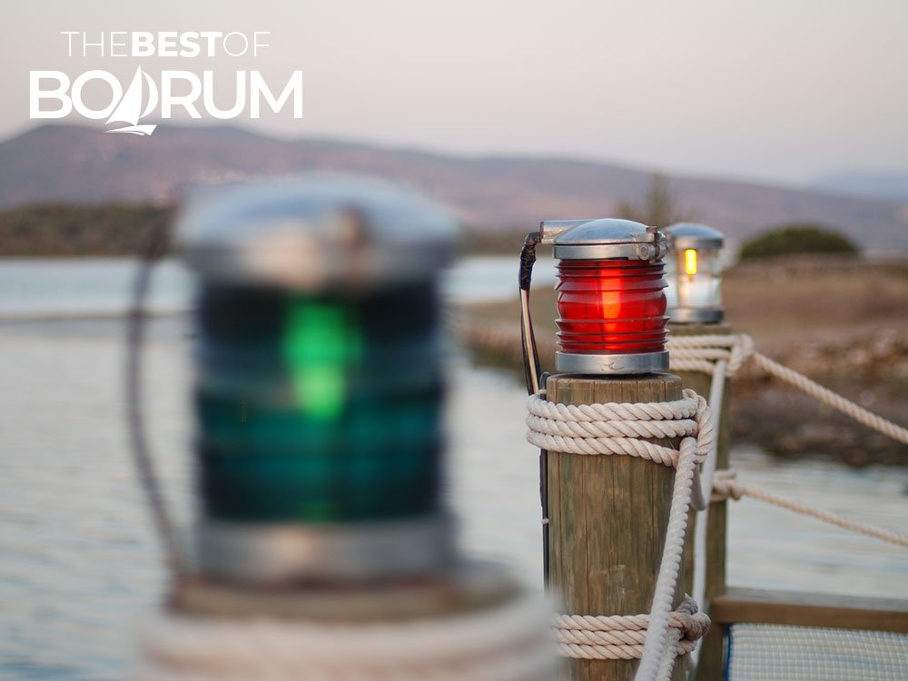 Electric lamps by the sea in Bodrum, reminding travellers about electricity in Turkey travel tips.