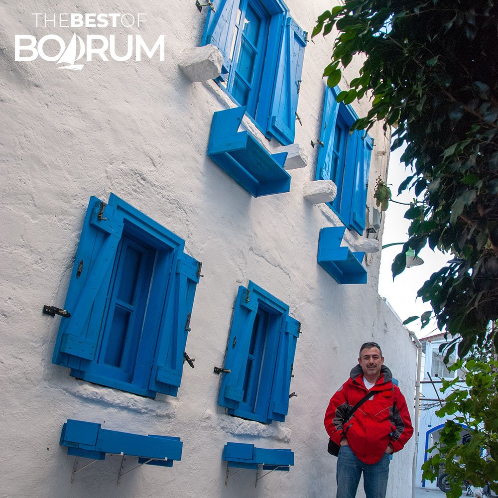 Author walking through Bodrum’s old town streets with blue shutters and whitewashed walls, showing another side of Bodrum attractions.