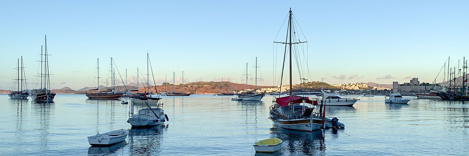 Boats anchored in the calm morning light during sunrise in Bodrum.